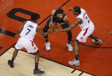 Raptors' Kyle Lowry (left) and Kawhi Leonard (right) guard Orlando Magic's Michael Carter-Williams during the fourth quarter on Tuesday night in Toronto. (JACK BOLAND/TORONTO SUN)