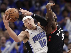 Orlando Magic's Aaron Gordon grabs a rebound away from Toronto Raptors' Serge Ibaka during the second half in Game 4 of a first-round NBA basketball playoff series, Sunday, April 21, 2019, in Orlando, Fla.