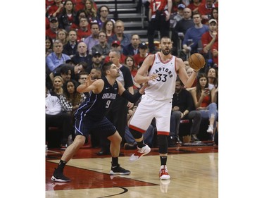 Toronto Raptors Marc Gasol C (33) deals off as he is guarded by Orlando Magic Nikola Vucevic C (9) during the first quarter in Toronto, Ont. on Saturday April 13, 2019. Jack Boland/Toronto Sun/Postmedia Network