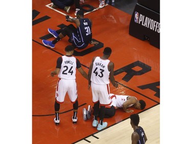 Toronto Raptors Kyle Lowry PG (7) lies on the court after being charged by Orlando Magic Terrence Ross SG (31)  during the second quarter in Toronto, Ont. on Saturday April 13, 2019. Jack Boland/Toronto Sun/Postmedia Network