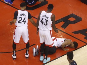 Kyle Lowry lies on the court after taking a knee to the groin from Magic’s Terrence Ross yesterday at Scotiabank Arena.                                              Jack Boland/Toronto Sun