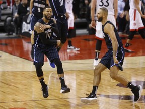Magic D.J. Augustin PG (14) is pumped after he drained a three-pointer to win  Game 1 against the Raptors on Saturday. Jack Boland/Toronto Sun/Postmedia Network