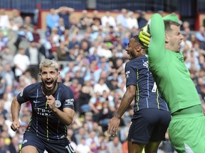 Manchester City’s Sergio Aguero (left) celebrates after scoring his side’s opening goal on Sunday’s against Burnley. (THE ASSOCIATED PRESS)