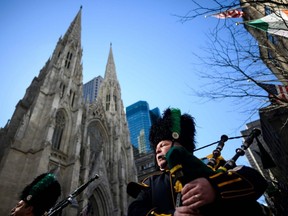 Bagpipers pass St. Patrick's Cathedral during the annual St. Patrick's Day Parade in New York City on March 16, 2019.