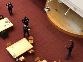 An unidentified man armed with a knife urged Toronto Police to shoot him, forcing an officer to use a Taser to subdue him, in the Toronto Reference Library near Yonge and Bloor Sts. on Monday, April 1, 2019. (screenshot from YouTube video)