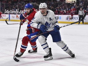 Maple Leafs centre John Tavares (right) battles against the Montreal Canadiens' Phillip Danault on Saturday night, the final regular-season game for both squads. (Minas Panagiotakis/Getty Images)