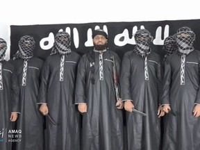 Sri Lanka suicide bombers line up for a team photo. Mastermind Zahran Hashim is the one without the mask.