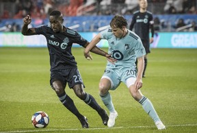 Toronto FC midfielder Richie Laryea battles for the ball with Minnesota United midfielder Rasmus Schuller last night at BMO Field.  
(Christopher Katsarov 
/The Canadian Press)