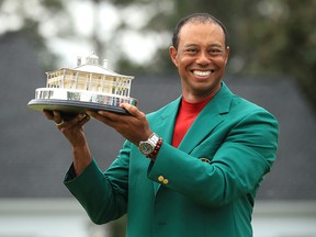 Tiger Woods celebrates with the Masters Trophy during the Green Jacket Ceremony after winning the Masters at Augusta National Golf Club on April 14, 2019 in Augusta, Georgia. (Andrew Redington/Getty Images)