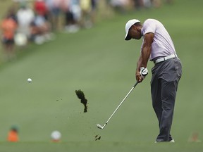 Tiger Woods hits his fairway shot on No. 1 during the third round of the Masters Saturday, April 13, 2019, at Augusta National in Augusta, Ga. (Curtis Compton/Atlanta Journal-Constitution via AP)