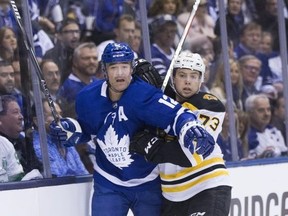 Toronto Maple Leafs centre Patrick Marleau and Boston Bruins defenceman Charlie McAvoy on the boards as the Toronto Maple Leafs take on the Boston Bruins in Game 3 in Toronto on Monday April 15, 2019.