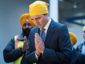 Prime Minister Justin Trudeau pauses and bows his head at the Khalsa Diwan Society Sikh Temple before marching in the Vaisakhi parade, in Vancouver on Saturday April 13, 2019. (THE CANADIAN PRESS/Darryl Dyck)
