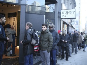 People line up to visit the Hunny Pot marijuana shop as it opens on Queen St. W. in Toronto on April 1, 2019 in Toronto. Veronica Henri/Toronto Sun