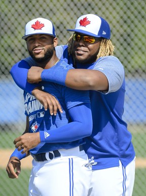 Vladimir Guerrero Jr., right, hugs teammate Richard Urena during baseball spring training. The Jays super prospect’s positive attitude is one of his most impressive attributes. THE CANADIAN PRESS