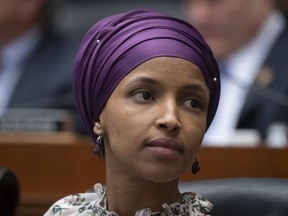 In this March 6, 2019, file photo, Rep. Ilhan Omar, D-Minn., sits with fellow Democrats on the House Education and Labor Committee during a bill markup, on Capitol Hill in Washington.