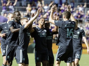 Orlando City's Nani (centre) celebrates with teammates after scoring against the Vancouver Whitecaps earlier this season. (AP PHOTO)