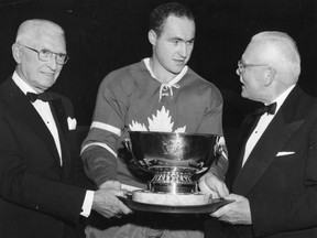 Toronto Maple Leafs player Leonard (Red) Kelly (centre) is presented with the J.D. Bickell Trophy for being the Leafs’ most valuable player by former prime minister Louis St. Laurent (right) and Maple Leafs chairman of the board W.A.H. MacBrien in an Oct.15, 1961 photo. Hockey legend Kelly, who starred for the Detroit Red Wings and Toronto Maple Leafs, has died at age 91. (THE CANADIAN PRESS)