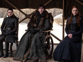 This image released by HBO shows from left to right Maisie Williams, Isaac Hempstead Wright and Sophie Turner in a scene from the final episode of "Game of Thrones," that aired Sunday, May 19, 2019. (HBO via AP)