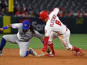David Fletcher of the Los Angeles Angels of Anaheim beats the tag by Freddy Galvis of the Toronto Blue Jays for a stolen base in the second inning in Anaheim on May 1, 2019.
