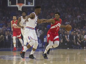 Kyle Lowry of the Toronto Raptors looks to be trying to straight-arm Jimmy Butler as dribbles against his friend and  Sixers opponent on Thursday night in Game 6 at Philly. (Photo by Mitchell Leff/Getty Images)
