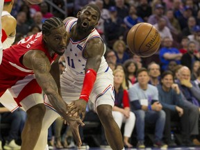 Raptors’ Kawhi Leonard (left) passes the ball while being defended by 76ers’ James Ennis. Leonard will become a free agent after this season and bowing out in the second round won’t look good on Masai Ujiri and the Raps.  Getty Images