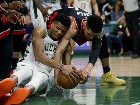 Giannis Antetokounmpo of the Milwaukee Bucks and Danny Green of the Toronto Raptors battle for a loose ball in the fourth quarter in Game One of the Eastern Conference Finals in Milwaukee last night. 
Getty Images  Jonathan Daniel/Getty Images)