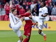 Toronto FC forward Jordan Hamilton gets caught between Philadelphia Union defender Jack Elliott (left) and teammate Ray Gaddis during Saturday's game. (THE CANADIAN PRESS)