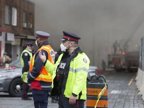 Emergency personnel are pictured at Tuesday's six-alarm blaze at York Memorial Collegiate. (Stan Behal, Toronto Sun)
