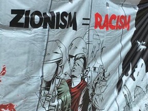 One of numerous anti-Zionist banners flown during an al-Quds day rally at Queen's Park  on June 9 2018. ( Joe Warmington, Toronto Sun)