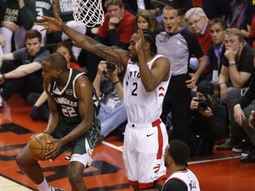 Toronto Raptors' Kawhi Leonard defends against Milwaukee Bucks' Khris Middleton during Tuesday's game. (JACK BOLAND/Toronto Sun)