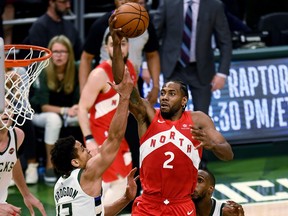 Raptors’ Kawhi Leonard goes to the hoop against Bucks’ Malcolm Brogdon during Game 5 of the Eastern Conference final in Milwaukee on Thursday night. (GETTY IMAGES)