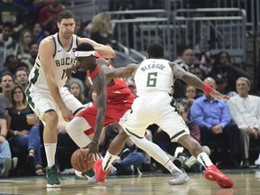 Toronto Raptors forward Pascal Siakam tries to split two Bucks defenders during Game 5 on Thursday. (THE CANADIAN PRESS)