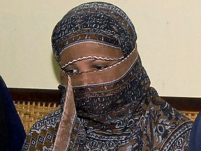 In this Nov. 20, 2010, file photo, Aasia Bibi, a Pakistani Christian woman, listens to officials at a prison in Sheikhupura near Lahore, Pakistan. (AP Photo, File)