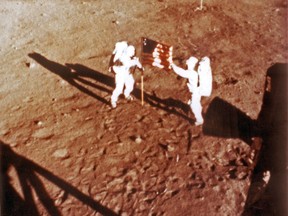 In this file photo taken on July 20, 1969 U.S. astronauts Neil Armstrong and "Buzz" Aldrin deploy the U.S. flag on the lunar surface during the Apollo 11 lunar landing mission.