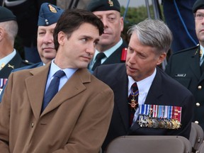 Justin Trudeau speaks with Liberal MP Andrew Leslie prior to a ceremony marking the one year anniversary of the attack on Parliament hill Thursday, Oct. 22, 2015, at the National War Memorial in Ottawa. (THE CANADIAN PRESS/Fred Chartrand)