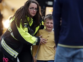 Officials guide students off a bus and into a recreation center where they were reunited with their parents after a shooting at a suburban Denver middle school Tuesday, May 7, 2019, in Highlands Ranch, Colo. (AP Photo/David Zalubowski) ORG XMIT: CODZ111A