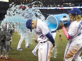 Toronto Blue Jays Cavan Biggio gets a Gatorade shower from teammate Vladimir Guerrero Jr. during a post-game interview after the Jays defeated the San Diego Padres 10-1 in their interleague MLB baseball game in Toronto, Sunday, May 26, 2019. THE CANADIAN PRESS/Fred Thornhill