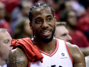 Toronto Raptors forward Kawhi Leonard (2) smiles from the bench late in second half action in Game 4 of the NBA Eastern Conference final against the Milwaukee Bucks in Toronto on Tuesday, May 21, 2019. The Raptors defeat the Bucks 120-102. THE CANADIAN PRESS/Frank Gunn ORG XMIT: FNG241