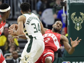 Kawhi Leonard of the Raptors crashes to the floor after standing in against Giannis Antetokounmpo during Game 5 on Thursday night, frustrating the Bucks big man. The Raps had a steady line of volunteers ready to take similar action. Frank Gunn/The Canadian Press