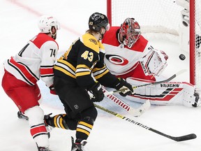 Danton Heinen of the Boston Bruins scores a third period goal against Petr Mrazek of the Carolina Hurricanes in Game 2 of the Eastern Conference Final during the 2019 NHL Stanley Cup Playoffs at TD Garden on May 12, 2019 in Boston.