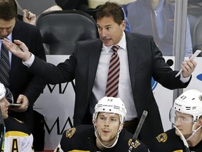 In this March 10, 2019, file photo, Boston Bruins head coach Bruce Cassidy gives instructions during the first period of an NHL hockey game against the Pittsburgh Penguins in Pittsburgh.