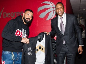 Drake, left, is given a diamond-studded jacket from Raptors president Masai Ujiri. (Raptors/Twitter)