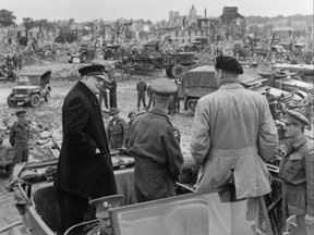 This file photograph taken on July 23, 1944, shows (L/R): British Prime minister Winston Churchill, Sir Miles Dempsey, British second Army commandant, and British Field Marshal Bernard Montgomery visiting the destroyed city of Caen, after Allied forces stormed the Normandy beaches on D-Day. (STF/AFP/Getty Images)