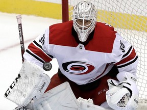 Carolina Hurricanes goaltender Curtis McElhinney blocks a shot during the third period of an NHL hockey game against the Pittsburgh Penguins in Pittsburgh, Sunday, March 31, 2019. (AP Photo/Gene J. Puskar)