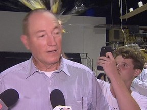 In this March 16, 2019, file image made from video, a teenager breaks an egg on the head of Senator Fraser Anning while he holds a press conference, in Melbourne. (AP Photo/File)