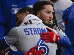 Blue Jays' Marcus Stroman hugs Freddy Galvis, right, after Galvis hit a home run during the second inning against the White Sox in MLB action in Chicago on Thursday, May 16, 2019.