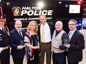 Quick thinking heroes came to the aid of Jean-Paul St. Jules, a Peel Regional Police, (in the yellow tie) who suffered a heart attack while reffing a hockey game. Halton Police Chief  Stephen Tanner (far left) and people who helped   St. Jule are pictured. (Greig Reekie photo)