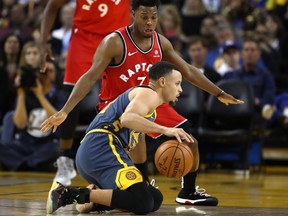 OAKLAND, CA - DECEMBER 12:  Stephen Curry #30 of the Golden State Warriors dribbles on his knees while being guarded by Kyle Lowry #7 of the Toronto Raptors at ORACLE Arena on December 12, 2018 in Oakland, California.  NOTE TO USER: User expressly acknowledges and agrees that, by downloading and or using this photograph, User is consenting to the terms and conditions of the Getty Images License Agreement.  (Photo by Ezra Shaw/Getty Images)