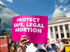 Protesters hold signs as they rally in support of Planned Parenthood and pro-choice and to protest a state decision that would effectively halt abortions by revoking the centre's license to perform the procedure, near the Old Courthouse in St. Louis, Missouri, May 30, 2019. (SAUL LOEB/AFP/Getty Images)