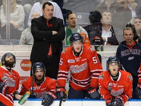Head coach DJ Smith of the Oshawa Generals gets onto the bench during the 2015 Memorial Cup Championship against the Kelowna Rockets at the Pepsi Coliseum on May 31, 2015 in Quebec City, Quebec, Canada.